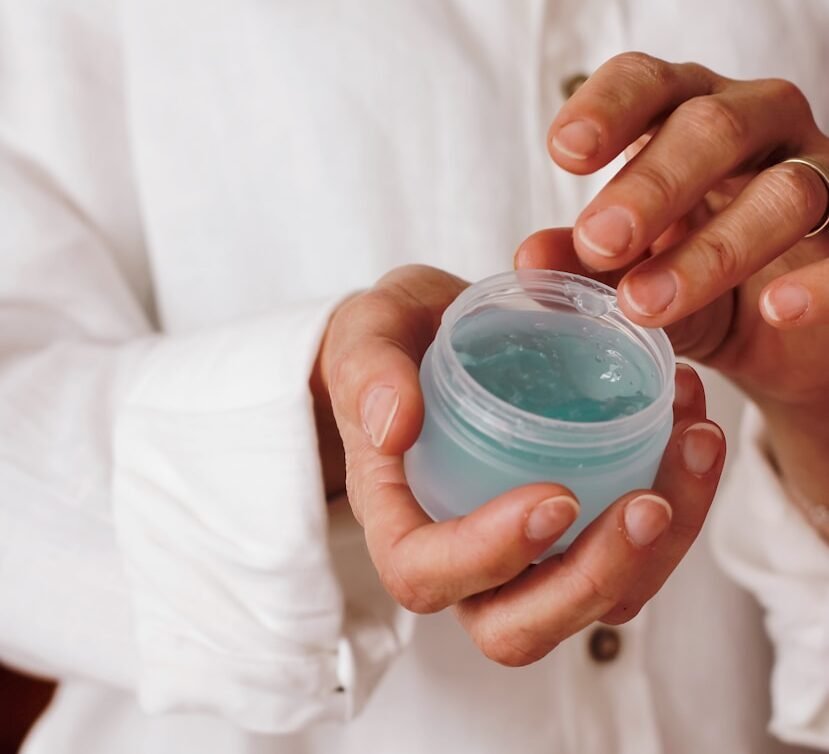 person holding blue plastic container